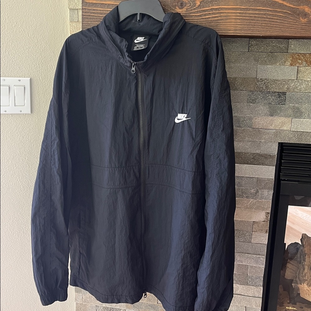 Nike Black Windbreaker Jacket, zippered collar for hood. Two pockets